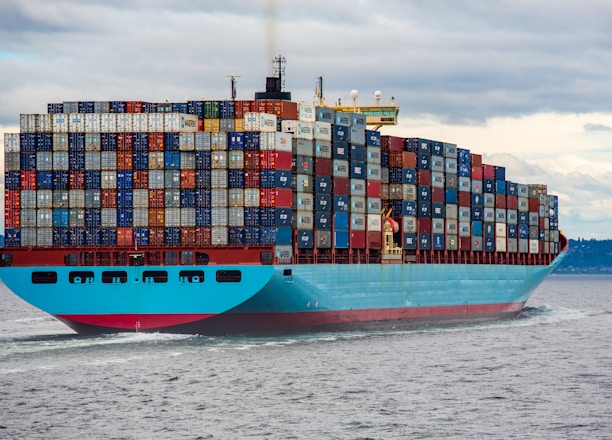 blue and red cargo ship on sea during daytime